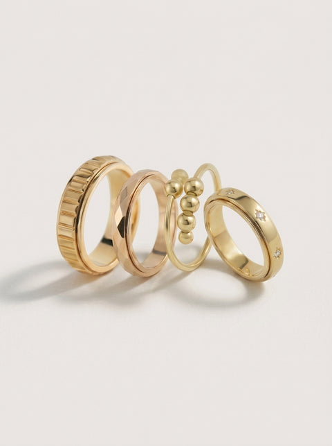Set of gold rings on a light gray background