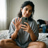 Woman taking a selfie in a casual setting with a phone