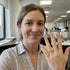 Person in an office setting showing a ring on their finger