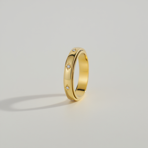 Gold ring with small diamonds on a light gray background
