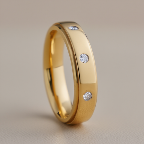 Gold ring with embedded diamonds on a beige background