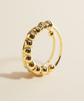 Gold hoop earring on a beige background