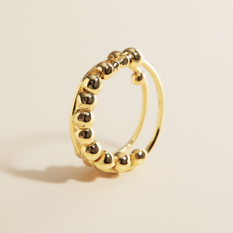 Gold hoop earring on a beige background