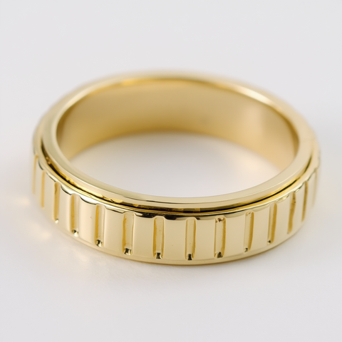Gold ring with a textured band on a white background