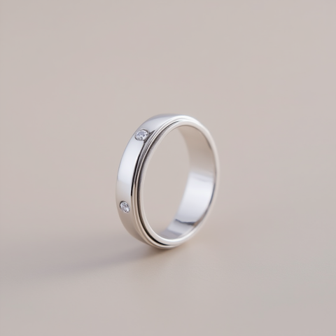 Silver ring with embedded diamonds on a beige background