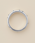 Silver ring with blue stones on a beige background