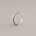 Silver ring on a beige background