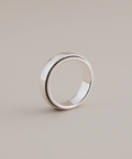 Silver ring on a beige background