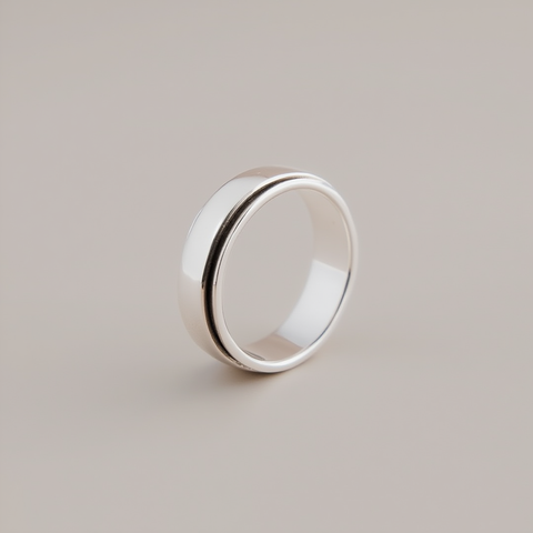 Silver ring on a light gray background