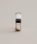 Silver ring on a light gray background