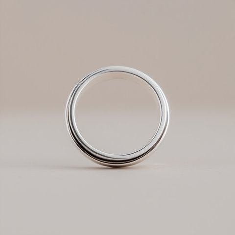 Silver ring on a beige background