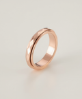 Rose gold ring on a light gray background