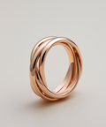 Rose gold ring with a modern design on a light gray background
