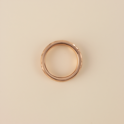 Rose gold ring on a beige background