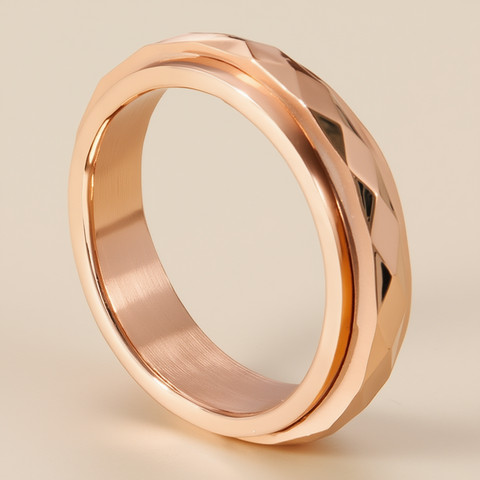 Rose gold faceted spinner anxiety ring on a beige neutral background 