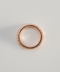 Rose gold ring on a light gray background