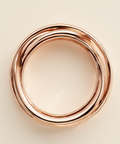 Rose gold ring on a beige background