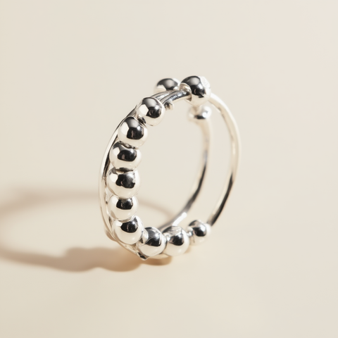 Silver hoop earring on a beige background