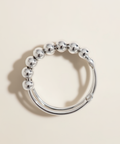 Silver beaded ring on a beige background