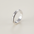 Silver ring on a light beige background