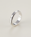 Silver ring on a light beige background