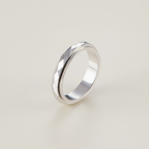 Silver ring on a light beige background