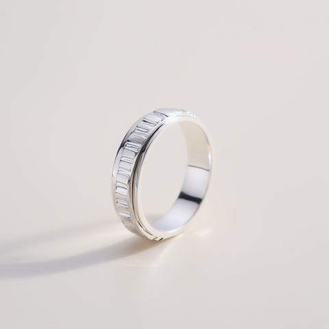 Silver ring with a textured band on a light gray background