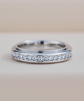 Silver ring with small diamonds on a light background