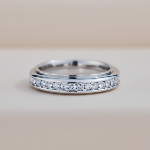 Silver ring with small diamonds on a light background