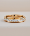 Gold ring with small diamonds on a beige background