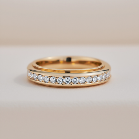 Gold ring with small diamonds on a beige background