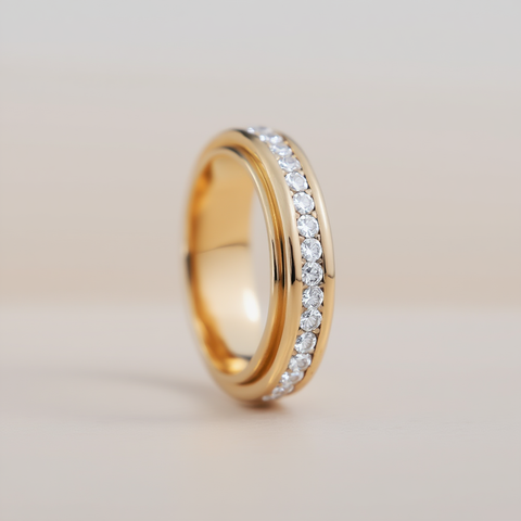 Gold ring with embedded diamonds on a light background