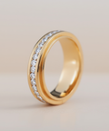 Gold ring with embedded diamonds on a light background