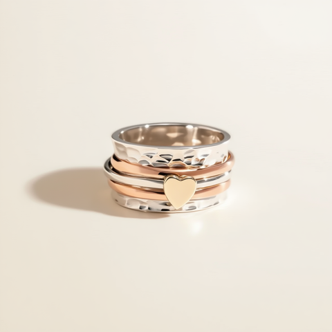 Stack of three gold rings on a beige background
