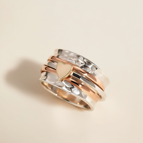 Three gold rings stacked on a beige background