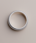 Silver ring on a beige background