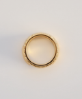 Gold ring on a light gray background
