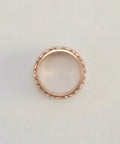 Rose gold ring on a light gray background