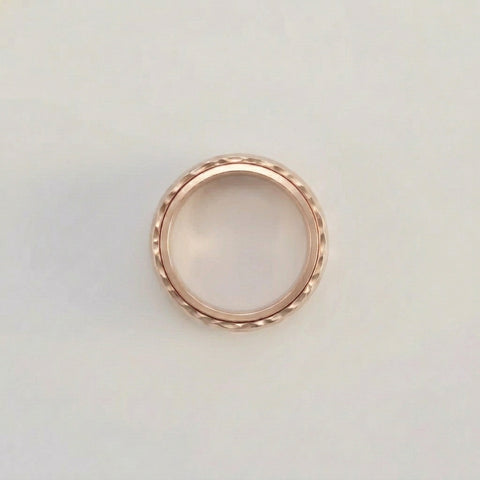 Rose gold ring on a light gray background