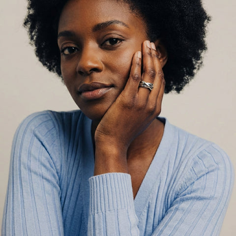 Woman wearing a light blue sweater with a neutral background