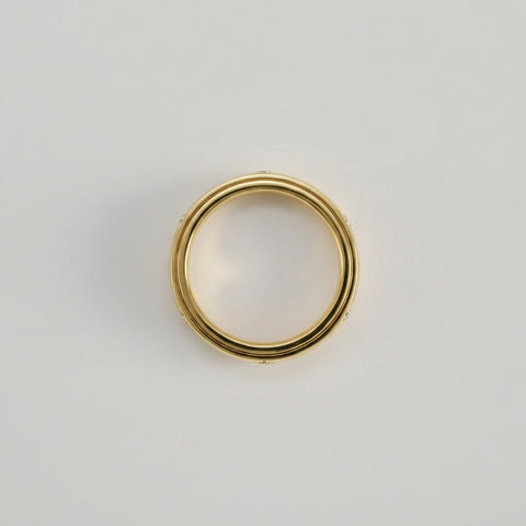 Gold ring on a light gray background
