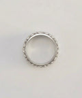 Silver ring on a light gray background