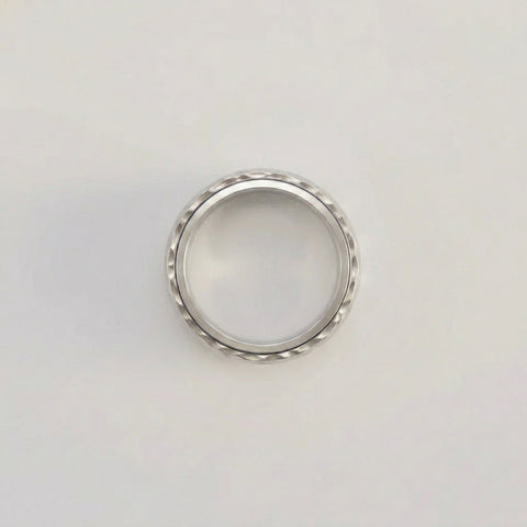 Silver ring on a light gray background