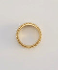 Gold ring on a light gray background