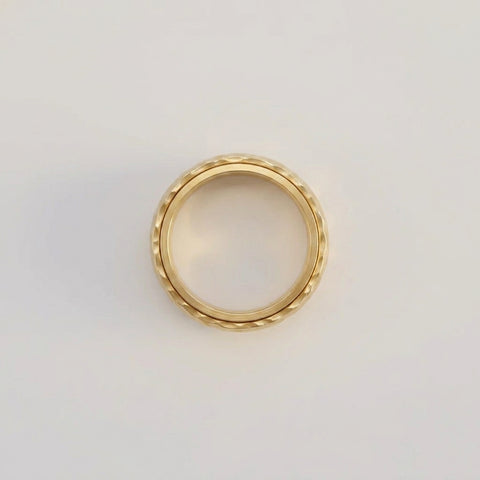 Gold ring on a light gray background
