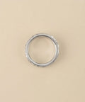 Silver ring on a beige background